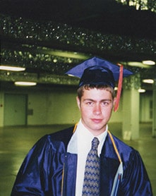 male student wearing cap and gown